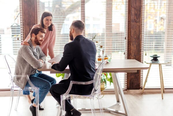 Home Warranty Protection - Couple Meeting With a Home Warranty Advisor in Their Home While Sitting at Their Kitchen Table